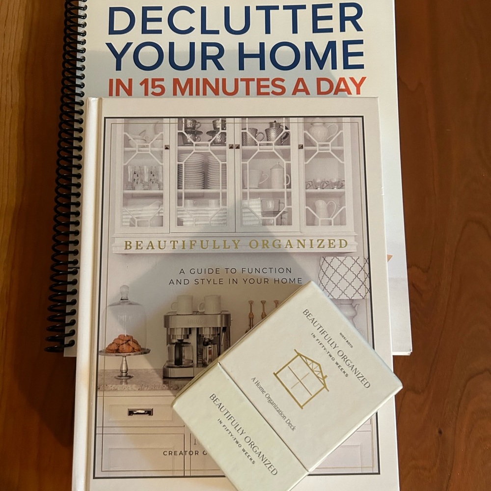 Decluttering books by Dawn Madsen, and Nikki Boyd. Two books, deck of cards.